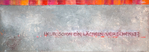 Wandbild in mittegrauer Farbe, gespachtelt strukturiert. Oben ein ca. 10 cm breiter Rand abwechselnd in den Farben rot,orange,pink. Ein Schriftzug mit dem Text: Heute schon ein Lächeln verschenkt? und links unten ein Smiley mit der Unterschrift "DU".