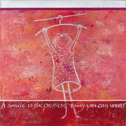 Wandbild mit dem Titel "A smile is the prettiest thing you can wear" von der Künstlerin Brigitte Anna Franck. Das Bild in Rot und Rosatönen zeigt ein lächelndes Kind, das an einem Kleiderbügel hängt. Der Titel des Bildes steht im unteren Bereich: A smile is the prettiest thing you can wear.